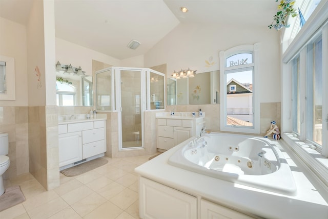 full bathroom with vanity, vaulted ceiling, tile patterned flooring, shower with separate bathtub, and toilet