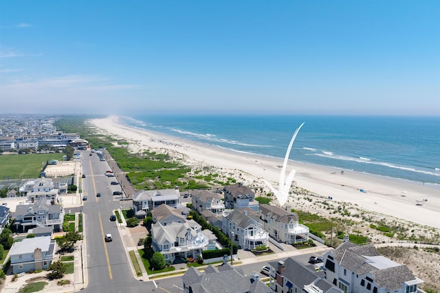 bird's eye view featuring a view of the beach and a water view