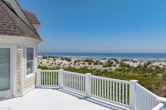 exterior space featuring a water view and a beach view