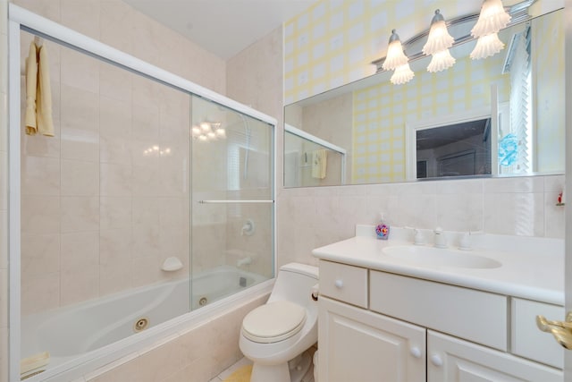 full bathroom with vanity, toilet, tile walls, and enclosed tub / shower combo