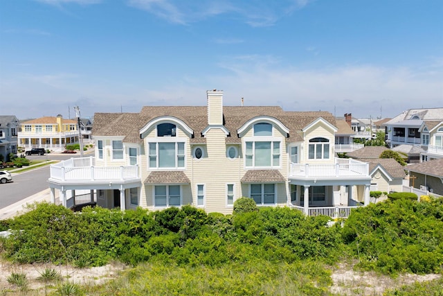 rear view of property with a balcony