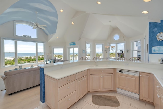 kitchen featuring dishwasher, light brown cabinetry, a water view, and sink