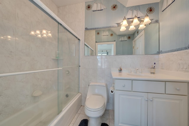 full bathroom with vanity, tile patterned floors, toilet, enclosed tub / shower combo, and tile walls