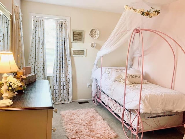 bedroom featuring multiple windows, visible vents, and carpet flooring