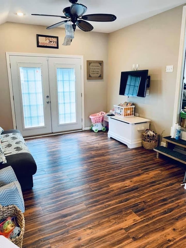 living area with lofted ceiling, a ceiling fan, wood finished floors, and french doors