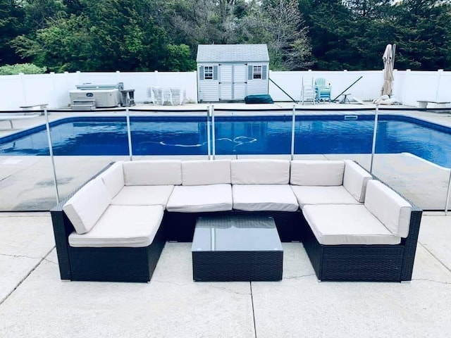 view of swimming pool featuring a fenced backyard and an outdoor living space