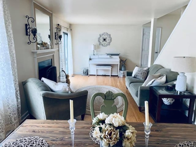 living area with a fireplace and wood finished floors