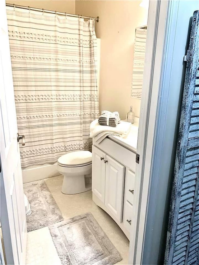 bathroom featuring toilet, tile patterned floors, and vanity