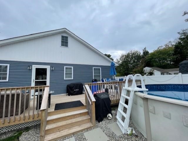 back of house with a swimming pool side deck