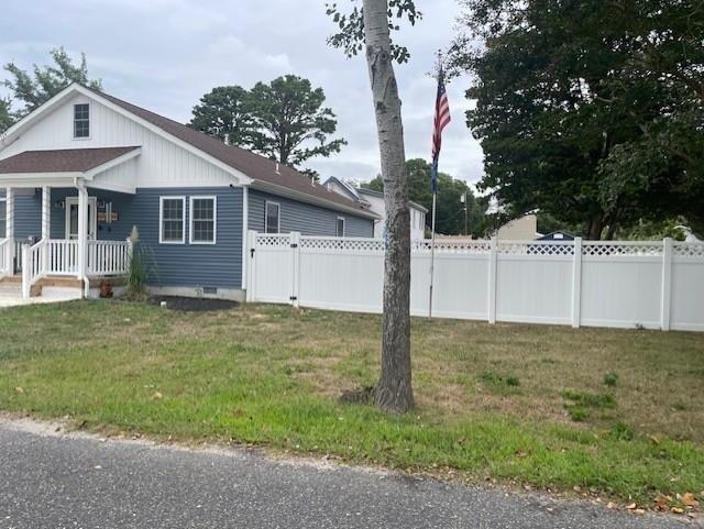 view of side of home featuring a lawn