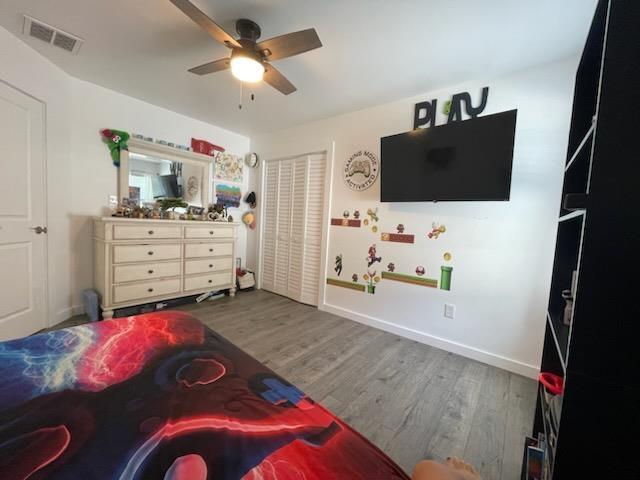 bedroom featuring ceiling fan and hardwood / wood-style flooring