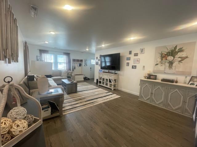 living room with dark hardwood / wood-style floors