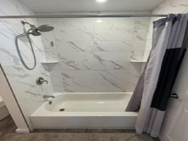 bathroom with shower / bath combination with curtain