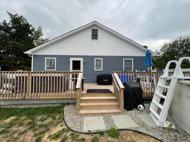 rear view of house with a wooden deck