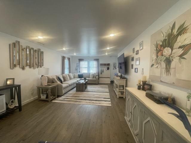 living room with dark hardwood / wood-style flooring