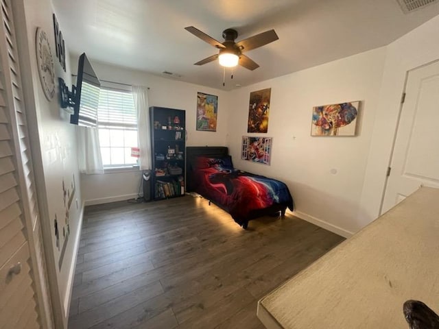 bedroom featuring dark hardwood / wood-style flooring and ceiling fan