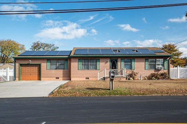 single story home featuring a front lawn, cooling unit, solar panels, and a garage