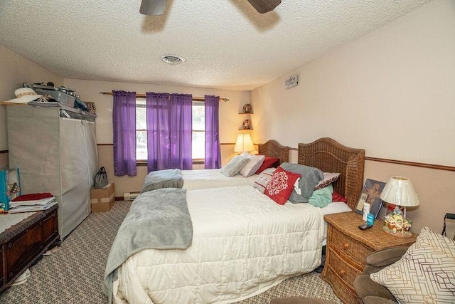 bedroom featuring a textured ceiling, ceiling fan, carpet, and baseboard heating