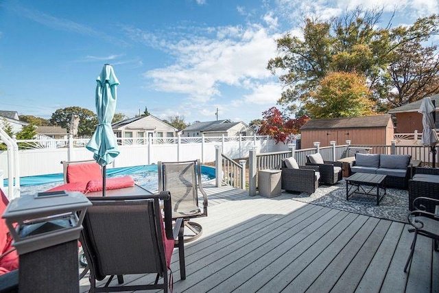 deck with an outdoor hangout area and a storage unit