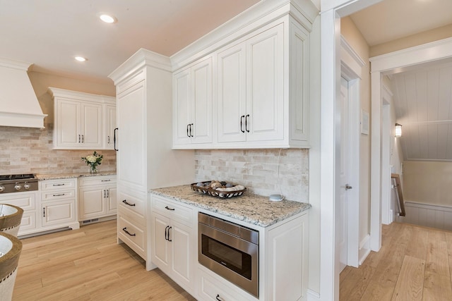 243 N Point Rd, Ocean City, NJ 08226 - kitchen featuring stainless steel appliances, premium range hood, white cabinets, and light hardwood / wood-style floors