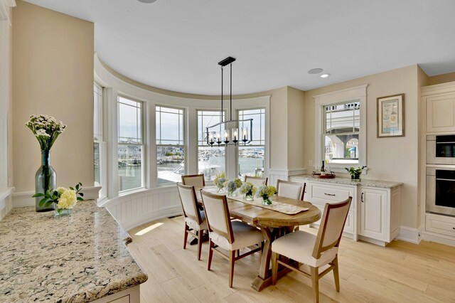 243 N Point Rd, Ocean City, NJ 08226 - dining area with a water view, a chandelier, and light wood-type flooring