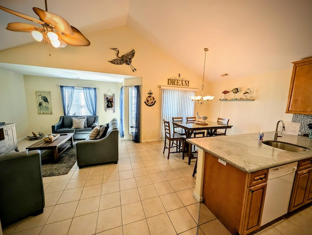 interior space featuring ceiling fan with notable chandelier, vaulted ceiling, and sink