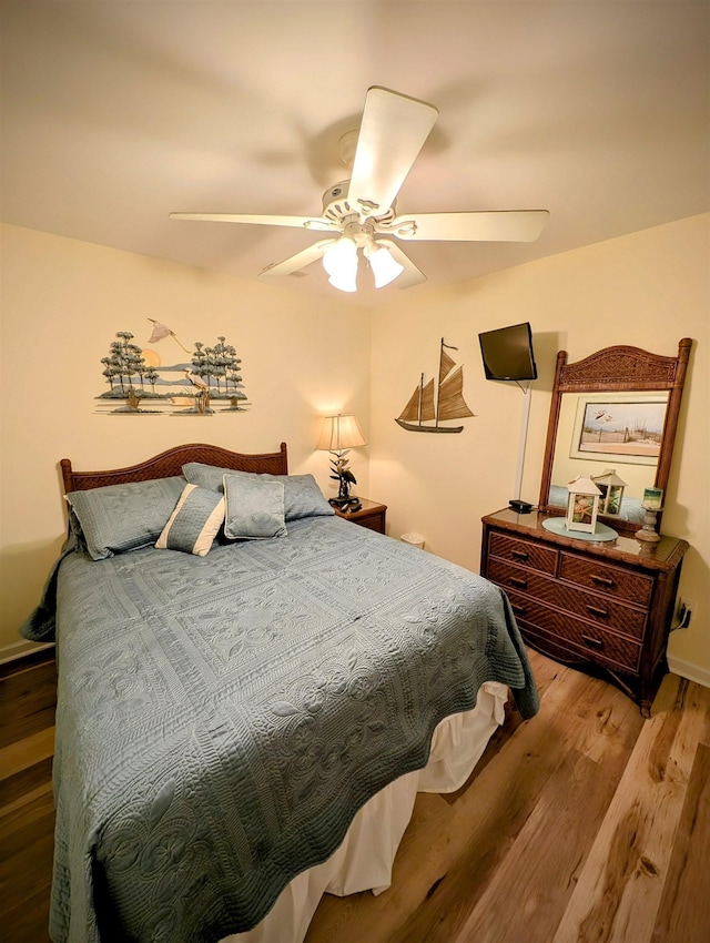 bedroom featuring wood-type flooring and ceiling fan