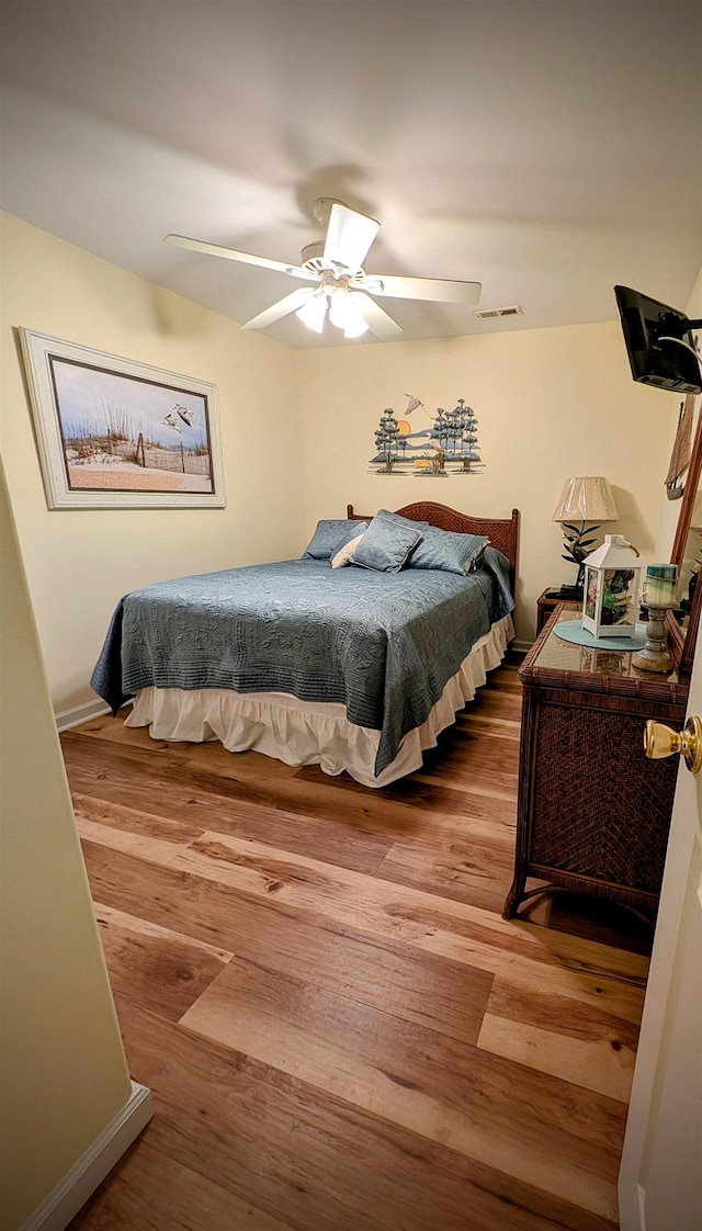 bedroom featuring ceiling fan and wood-type flooring