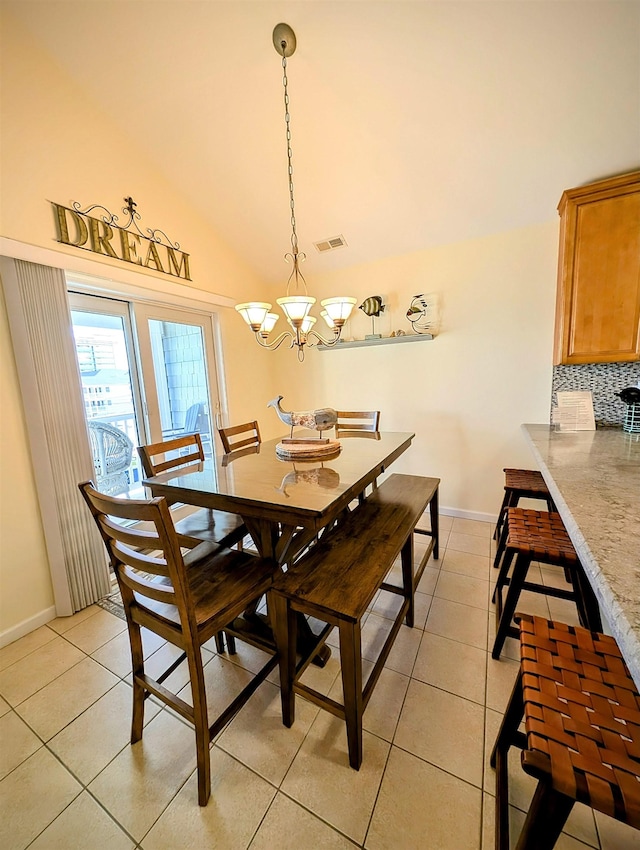 dining space featuring a notable chandelier and light tile patterned flooring