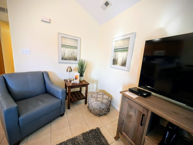 sitting room featuring light tile patterned floors and lofted ceiling