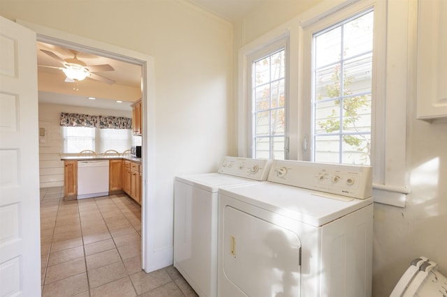 washroom featuring ceiling fan, washer and clothes dryer, and light tile patterned flooring