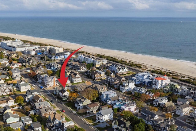 birds eye view of property featuring a view of the beach and a water view