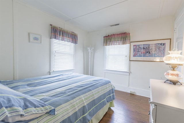 bedroom with dark hardwood / wood-style flooring