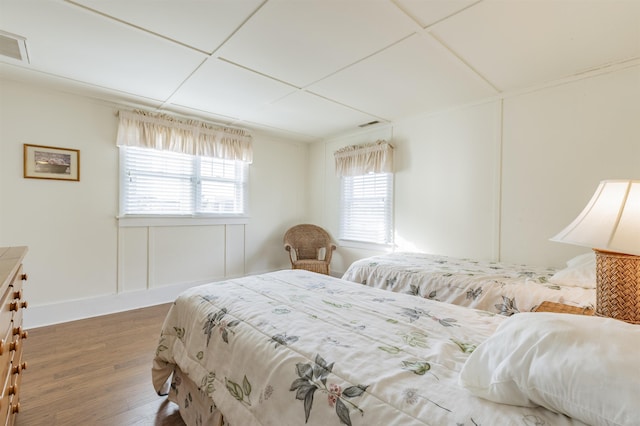 bedroom featuring multiple windows and hardwood / wood-style floors