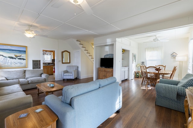 living room with ceiling fan and dark wood-type flooring