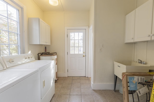 washroom with washing machine and dryer, plenty of natural light, cabinets, and ornamental molding