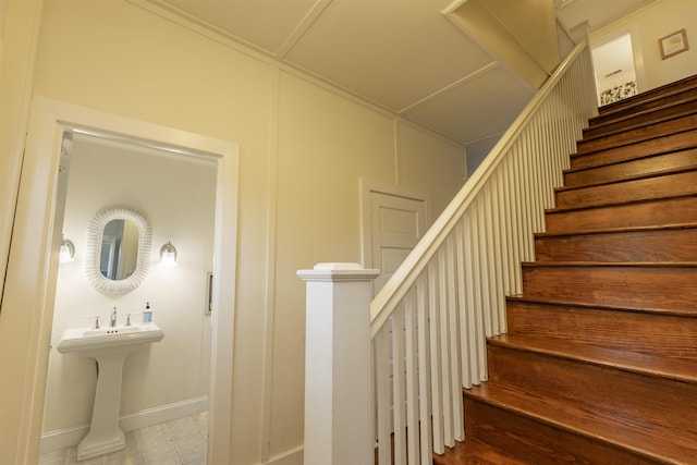 stairway featuring ornamental molding