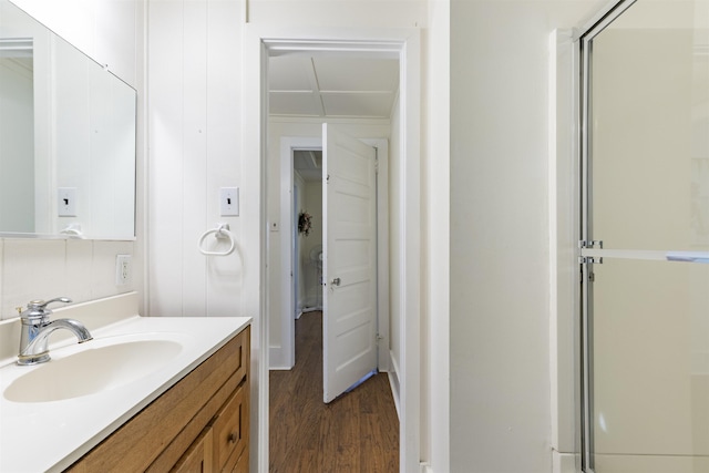 bathroom with vanity, wood-type flooring, and a shower with door