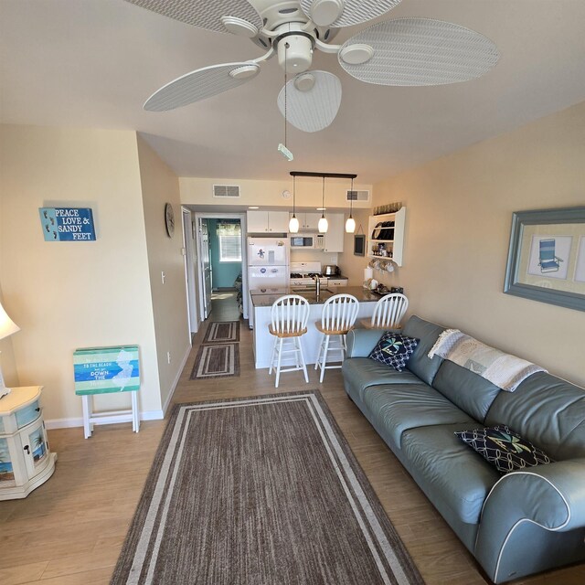 1800 Ocean Ave Unit 515, North Wildwood, NJ 08260 - living room with dark wood-style floors, ceiling fan, and baseboards