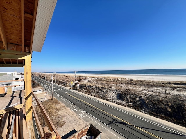 balcony featuring a beach view and a water view