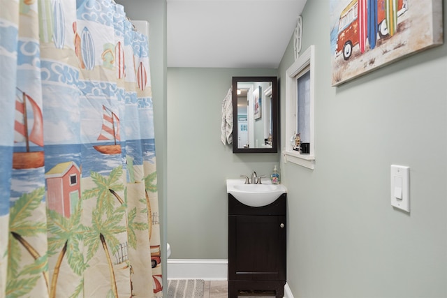 bathroom featuring vanity and curtained shower