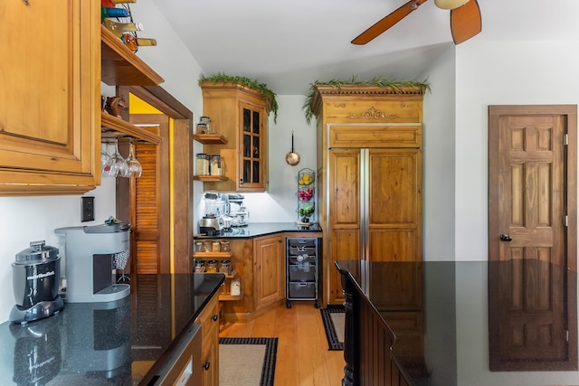 463 Rte 47 N, Goshen, NJ 08210 - kitchen featuring ceiling fan, light wood-type flooring, dark stone counters, open shelves, and glass insert cabinets