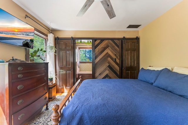 463 Rte 47 N, Goshen, NJ 08210 - bedroom with multiple windows, ceiling fan, a barn door, and wood finished floors