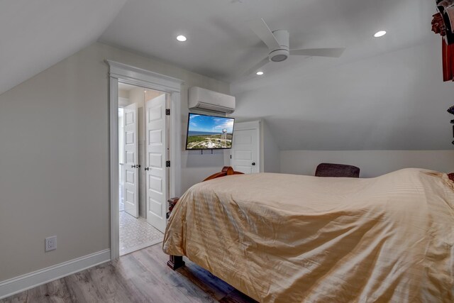 2901 Pacific Ave, Wildwood, NJ 08260 - bedroom with baseboards, a wall mounted AC, wood finished floors, and vaulted ceiling