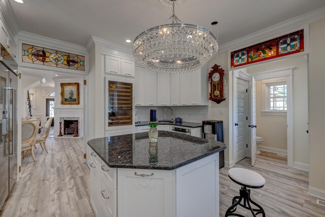 2901 Pacific Ave, Wildwood, NJ 08260 - kitchen featuring an inviting chandelier, white cabinets, a kitchen island, and ornamental molding