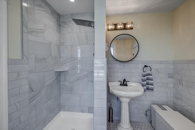 2901 Pacific Ave, Wildwood, NJ 08260 - bathroom featuring tile walls, toilet, a wainscoted wall, a sink, and tiled shower