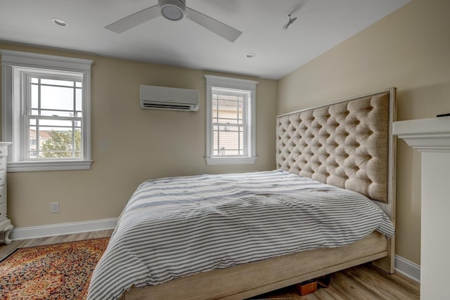 2901 Pacific Ave, Wildwood, NJ 08260 - bedroom with multiple windows, a wall unit AC, wood finished floors, and baseboards