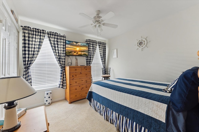 bedroom with a closet, light colored carpet, and ceiling fan