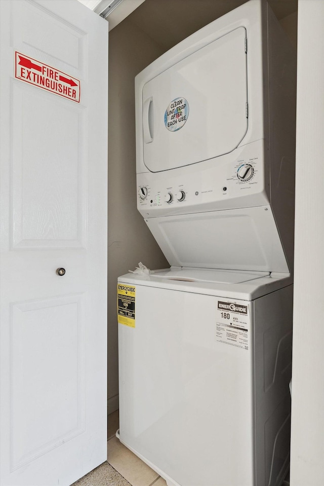 laundry area with stacked washing maching and dryer