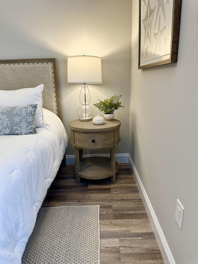 bedroom featuring baseboards and wood finished floors